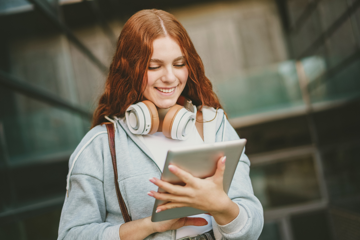 Una ragazzina felice utilizza un dispositivo digitale