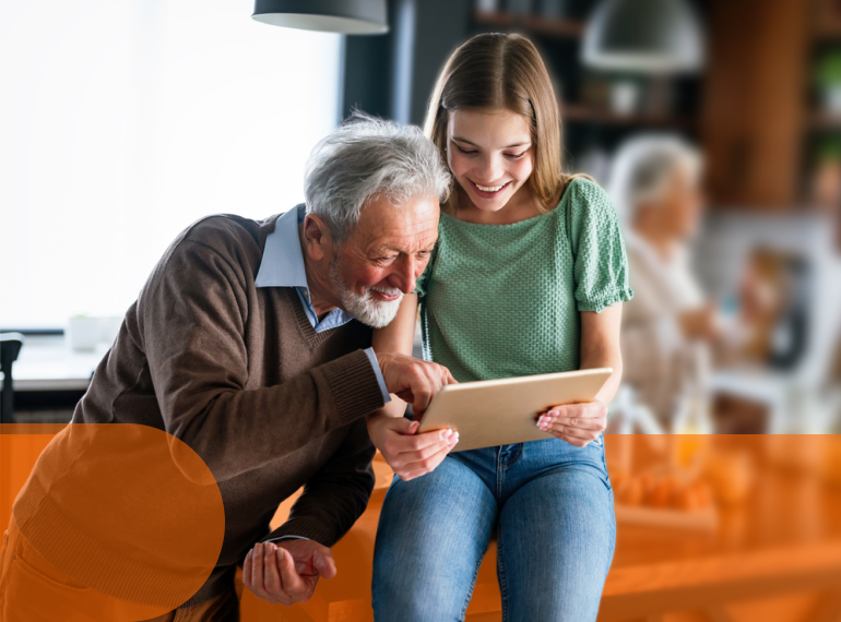 Nonno e nipotina guardano insieme un tablet