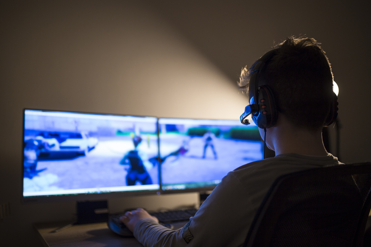 Ragazzo che gioca con un computer al buio